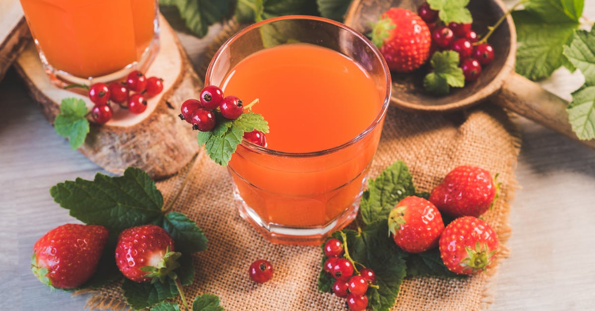 Freezing fresh juices - Strawberries on Table Beside Drinking Glass