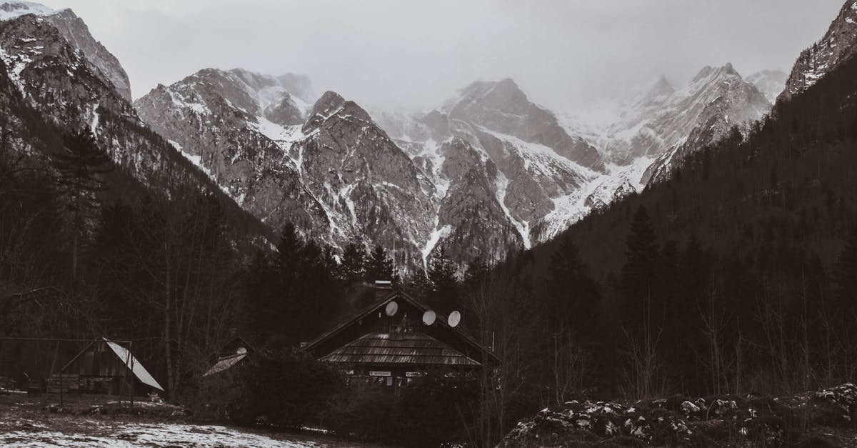 Freezing Tomatoes for Winter? - A Grayscale of a Cabin with Snow Covered Mountains on the Background