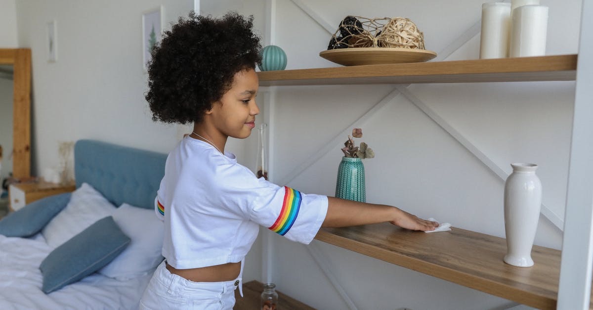 French Rolling Pin Care and Maintenance - Small girl cleaning shelf in apartment