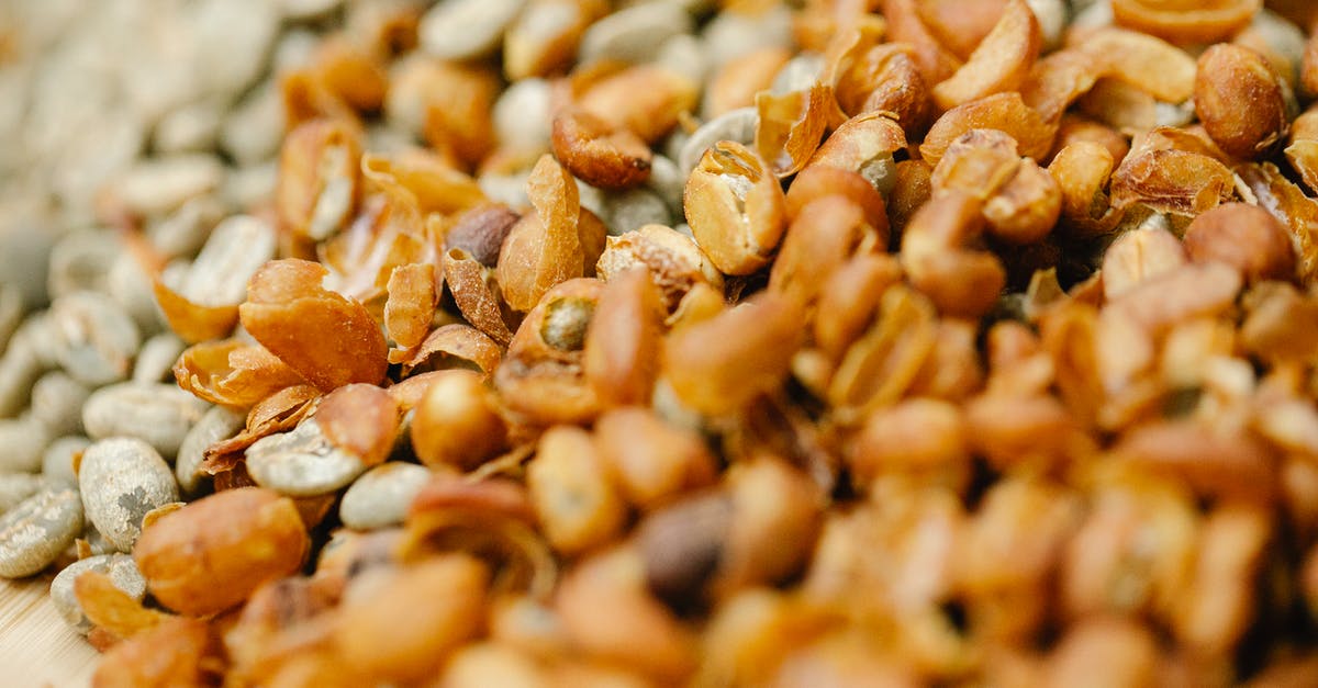 Fresh half and half curdles in hot coffee - Pile of raw coffee beans drying in sun