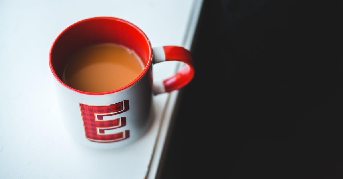 Fresh milk curdles when added to hot coffee and tea - Cup of coffee with milk on white table