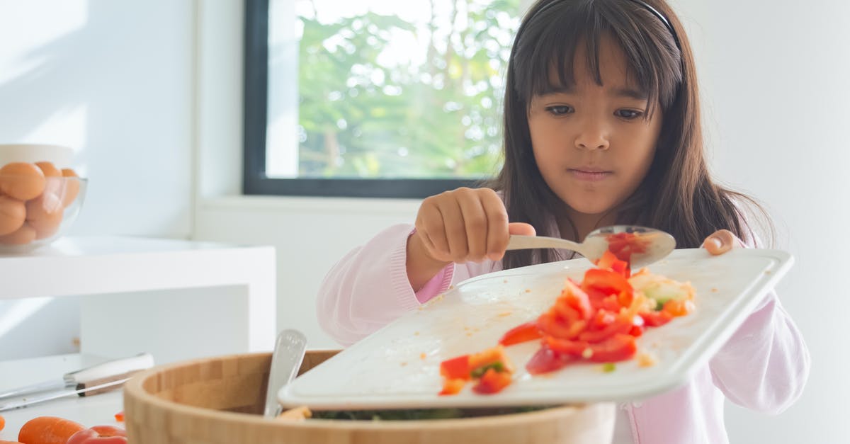 Fresh tomatoes for home-made pizzas, is it worth it? - Girl Holding Chopping Board with Sliced Tomatoes