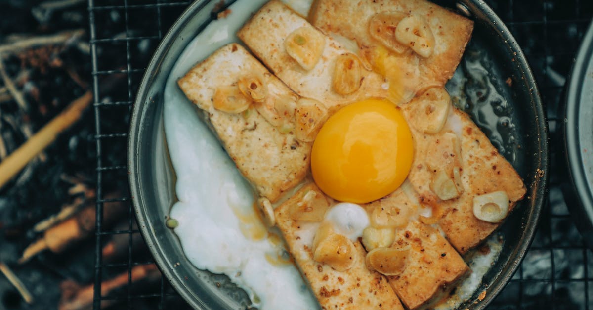 Fried garlic turning black - Appetizing egg toast roasting on pan