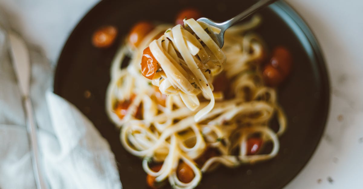 Fried Spaghetti - Pasta With White Cream on Black Ceramic Bowl