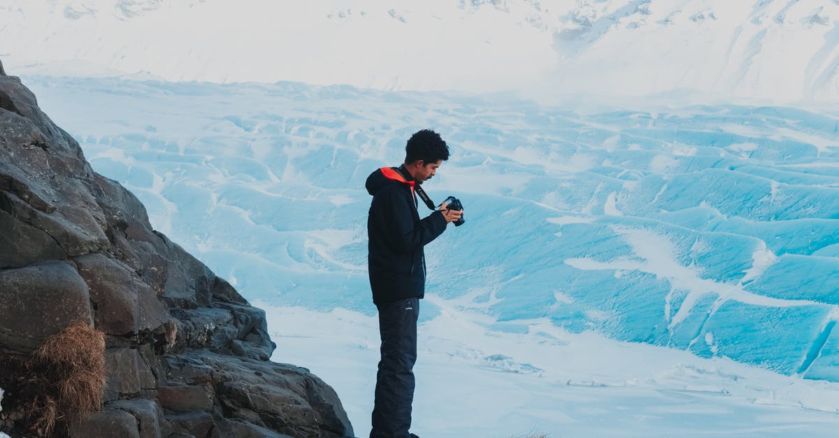 frozen chips always take longer - Man with camera in hands in winter mountains