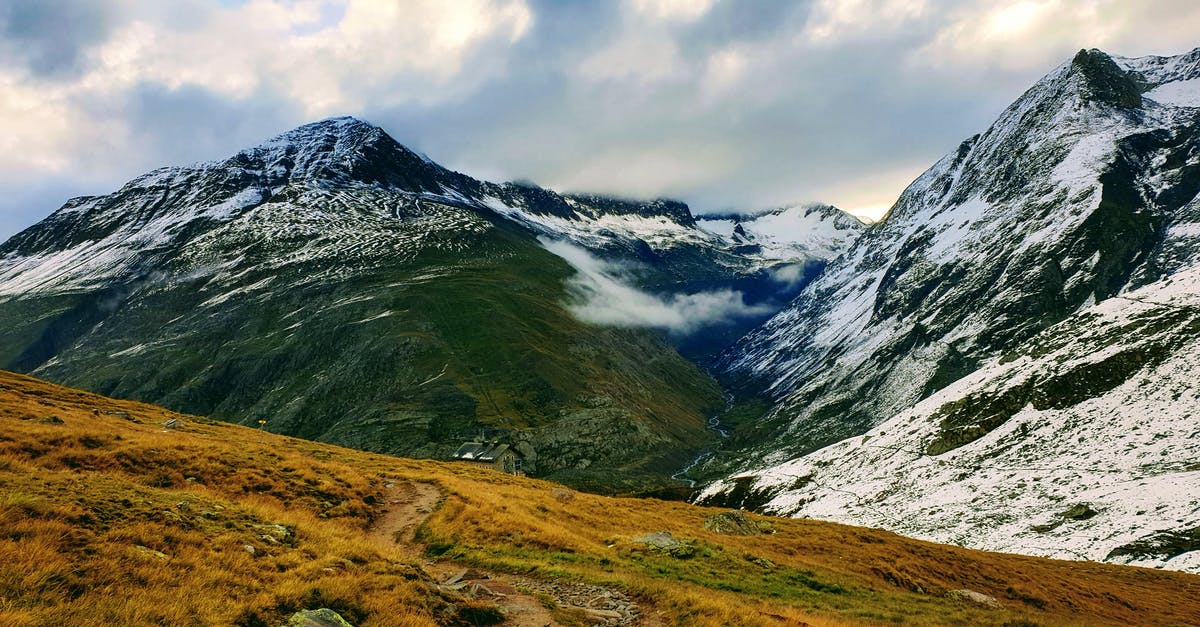 Frozen dinners extremely dry after reheating - Magnificent scenery of rough majestic mountains peaks covered with dry vegetation and snow under cloudy sky