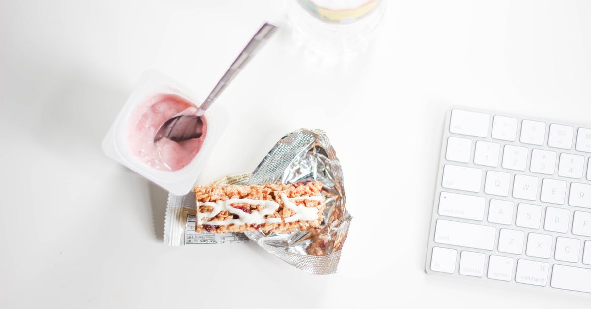 Frozen yogurt with inverted sugar - Flat Lay Photography of Yogurt With Pack of Crackers and Apple Magic Keyboard