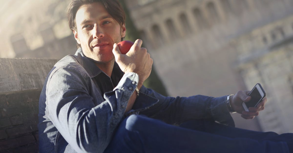 Fruit flavour profile - Young Man In Denim Jacket Holding Red Apple and Mobile Phone