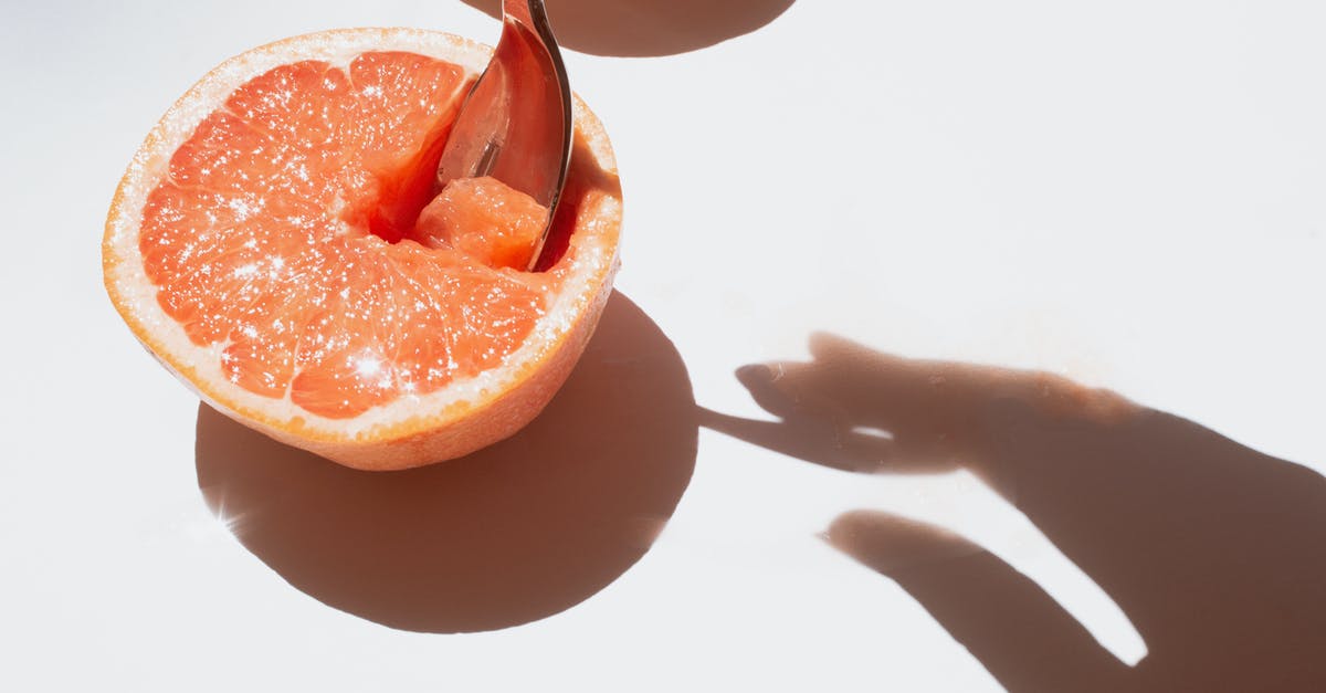 Fruit Flies and Storage of Fresh Produce - Sliced Grapefruit Fruit on White Surface