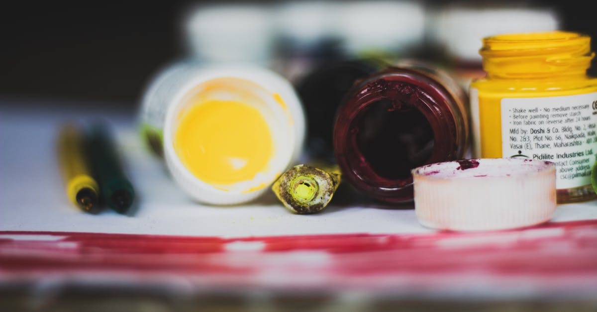 Fruit Oil Extraction - Selective Focus Photo of Opened Paint Containers