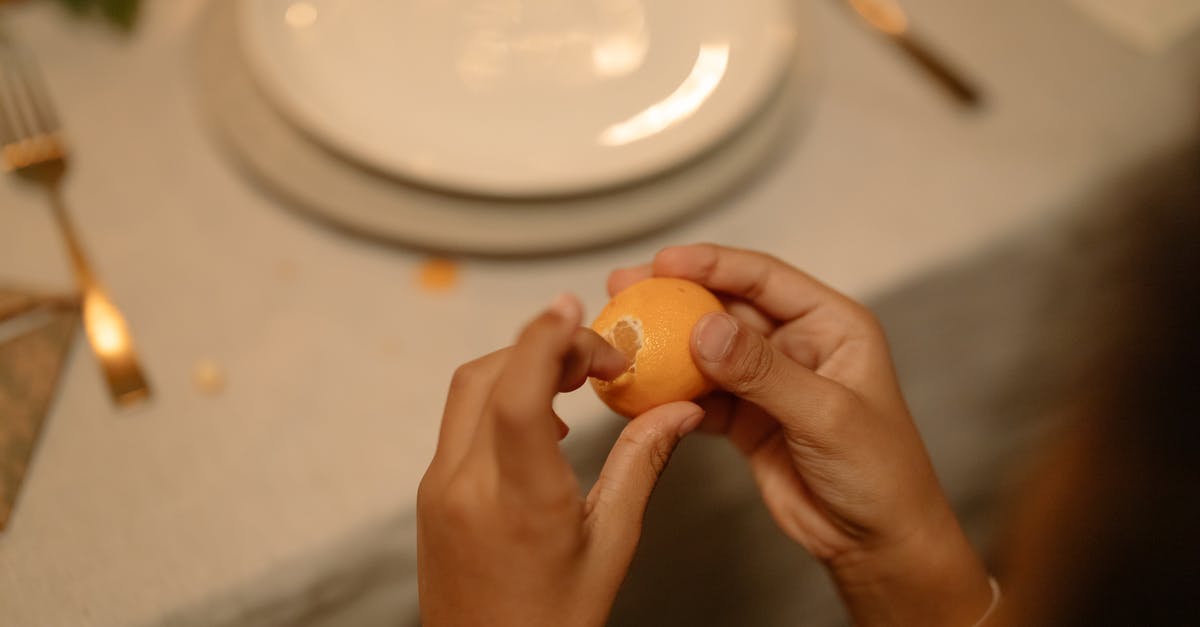 Fruit peeling techniques - Person Peeling a Lemon