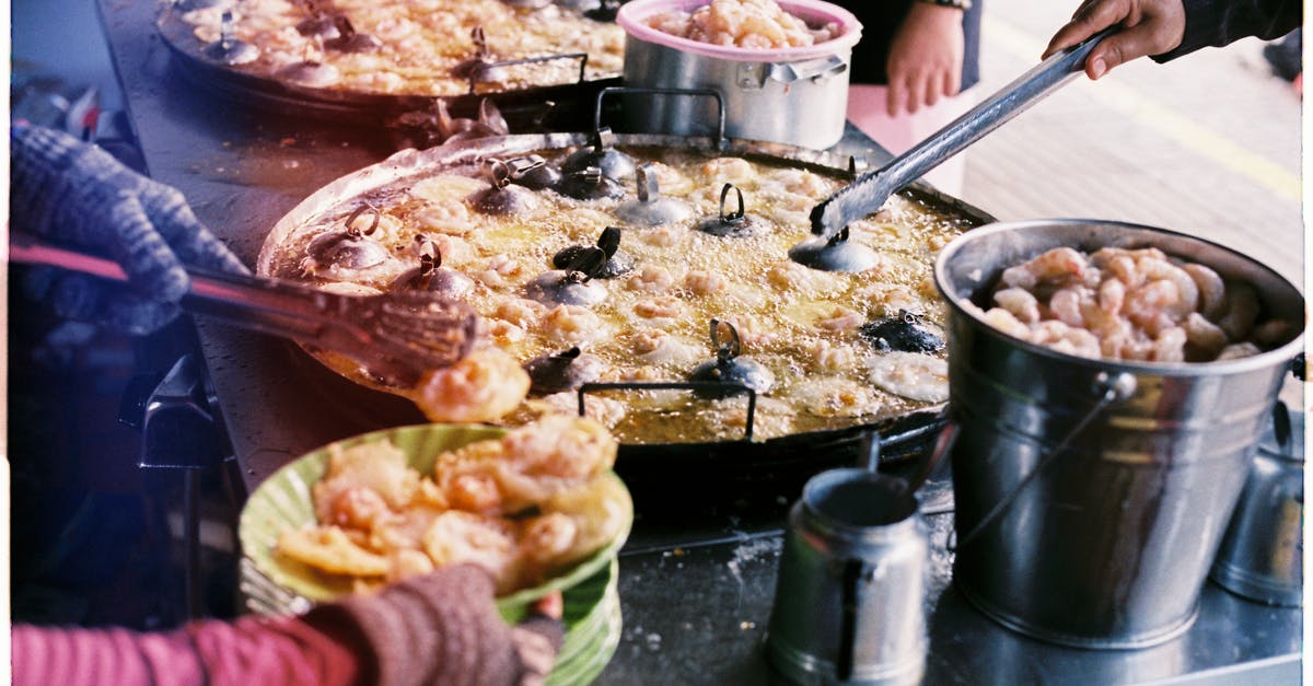 Frying with Induction Stovetop - Person Slicing Meat on Table