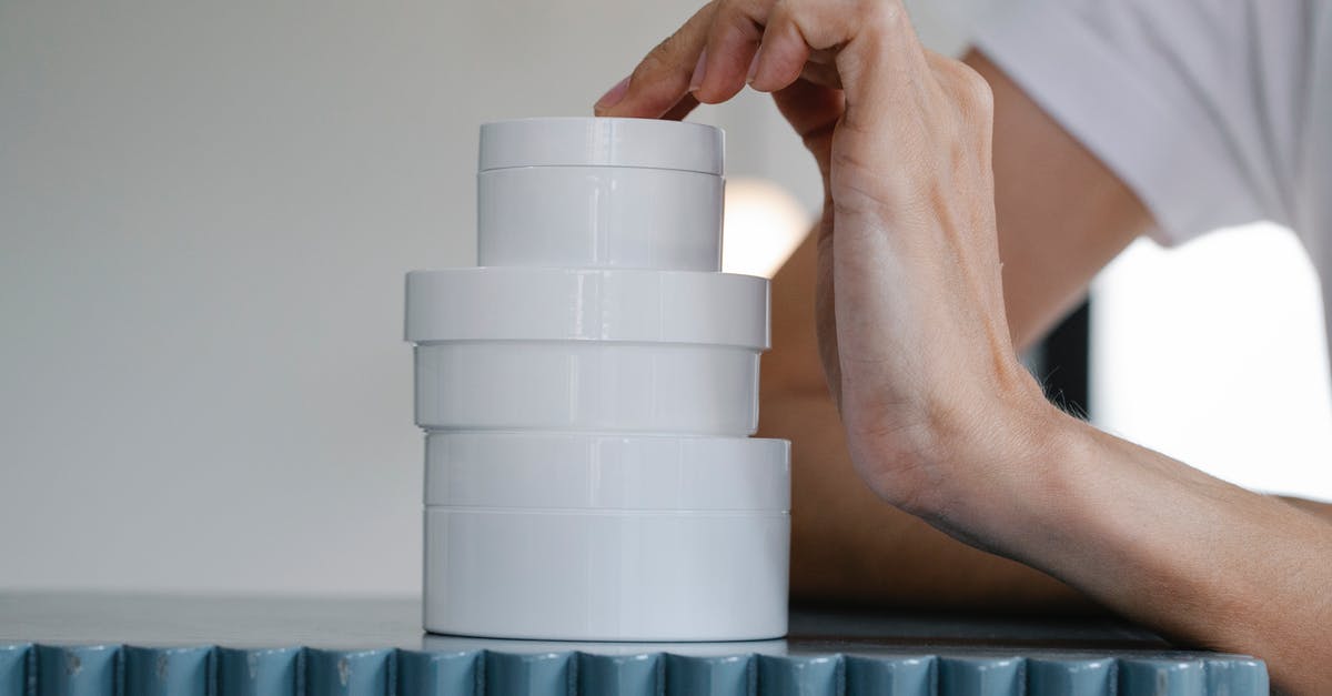 Fudge didn't set after doing it twice - Crop woman touching stack of blank jars of various creams