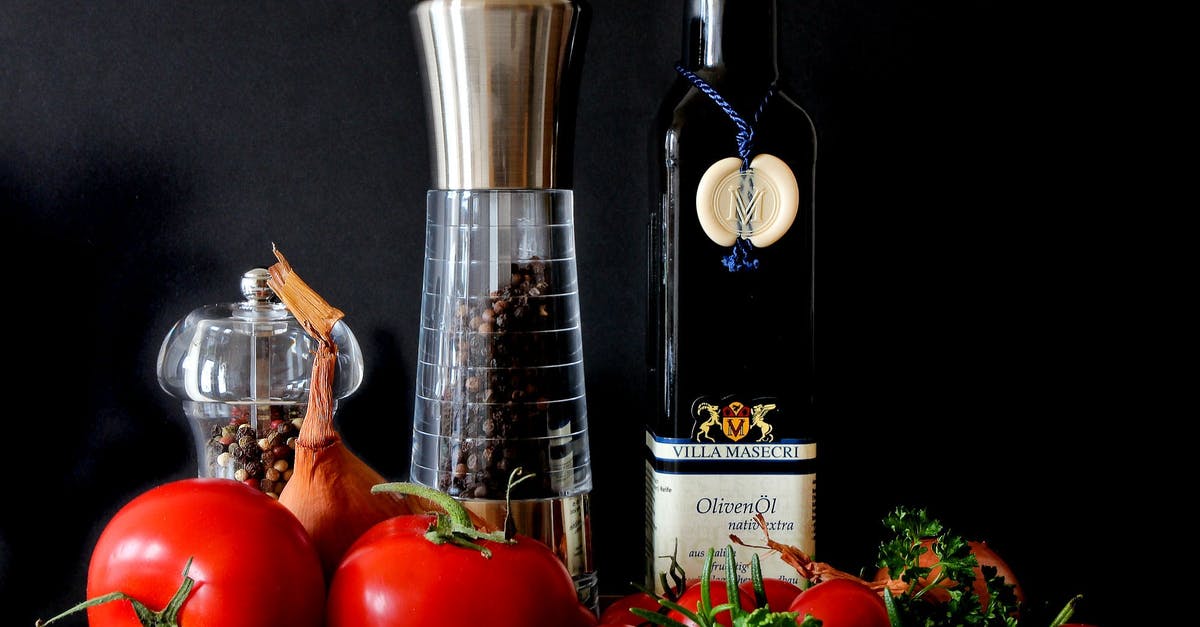 Garlic Infused Oil—Safety - Tomatoes Beside Shakers and Olive Oil Bottle