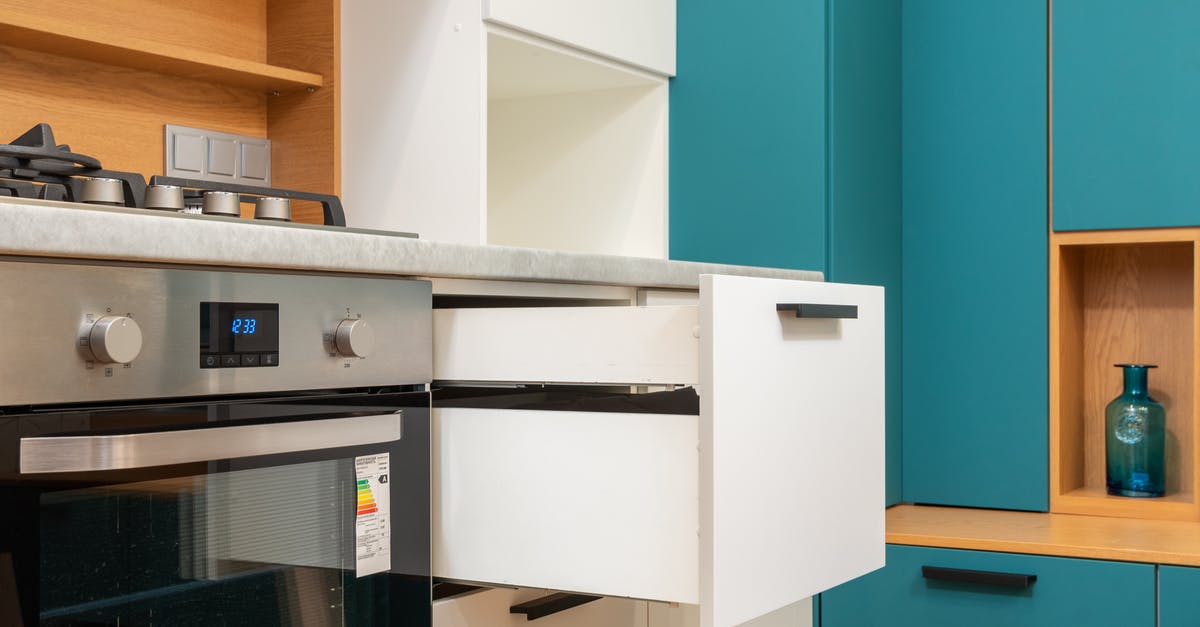 Gas or electric for rack oven in a bakery? - Open drawer of cabinet against oven in modern kitchen