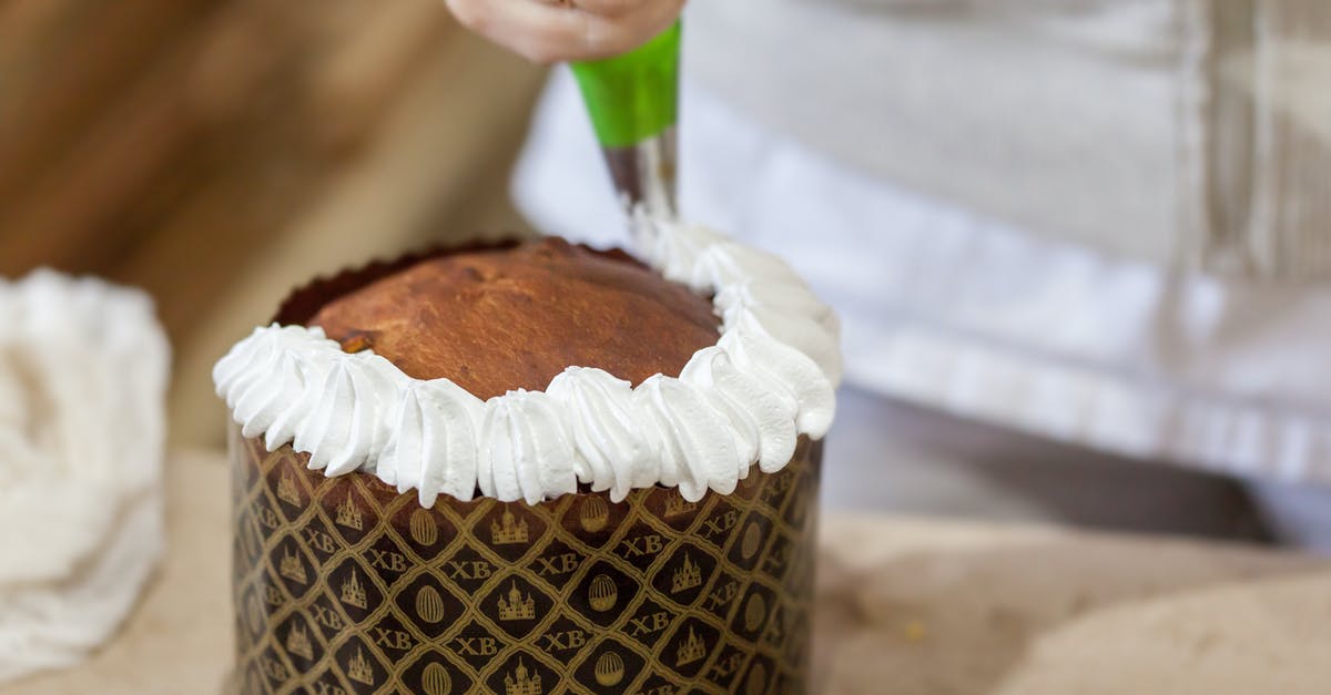 Genoise vs whipped egg whites - which makes cakes fluffier? - Crop pastry cook decorating Easter cake at work