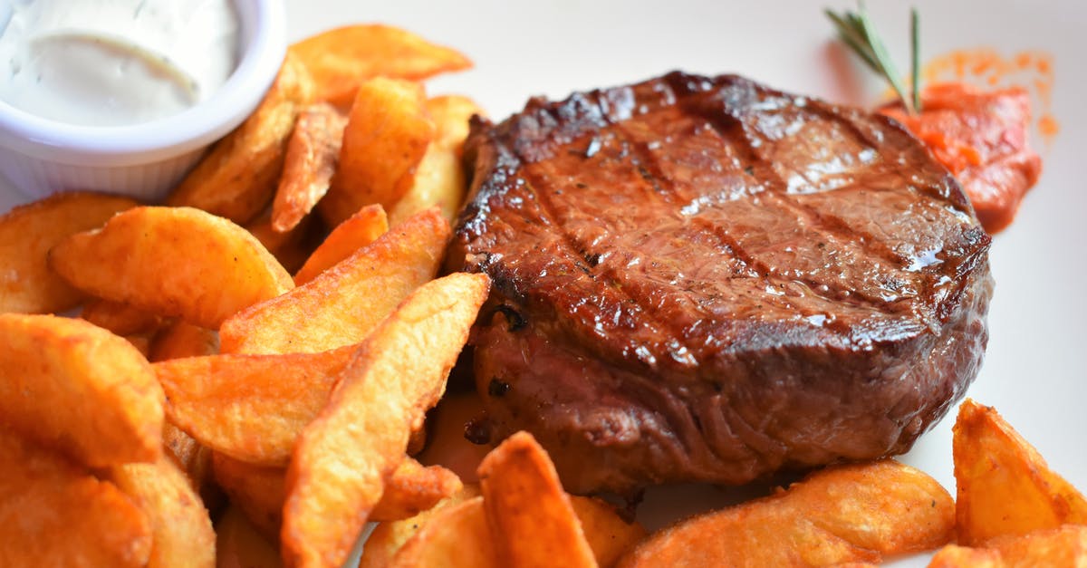 Getting dog meat to taste as close to steak as possible? - Roasted meat and fried potato on plate