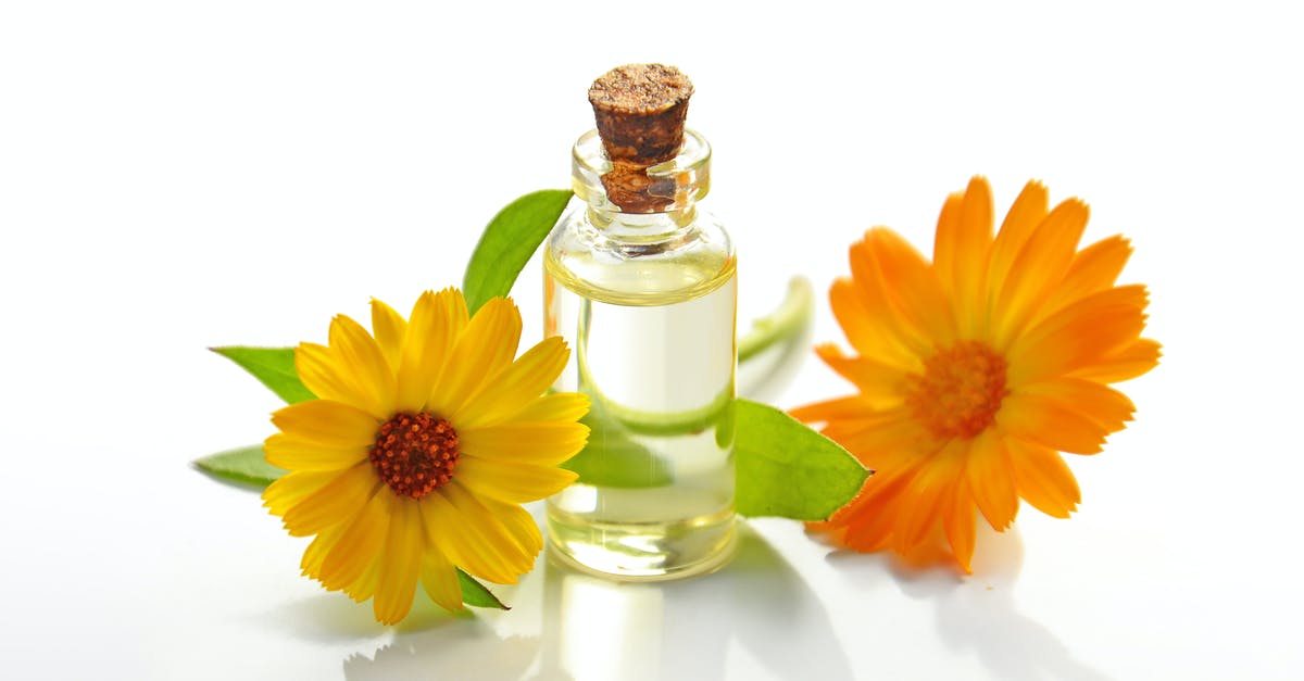 Getting oil residue out of a container - Two Yellow Sunflowers With Clear Glass Bottle With Cork Lid