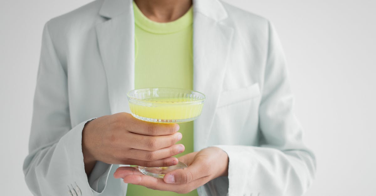 Getting the lighter fluid taste out of burgers, after the fact - Crop black woman with glass of cocktail