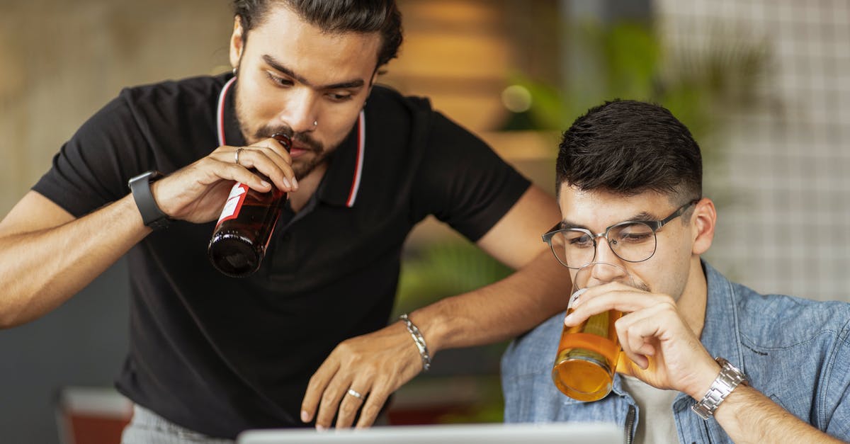 Glass bottle thickness ratings - Men Drinking Beer and Looking at a Laptop Screen 