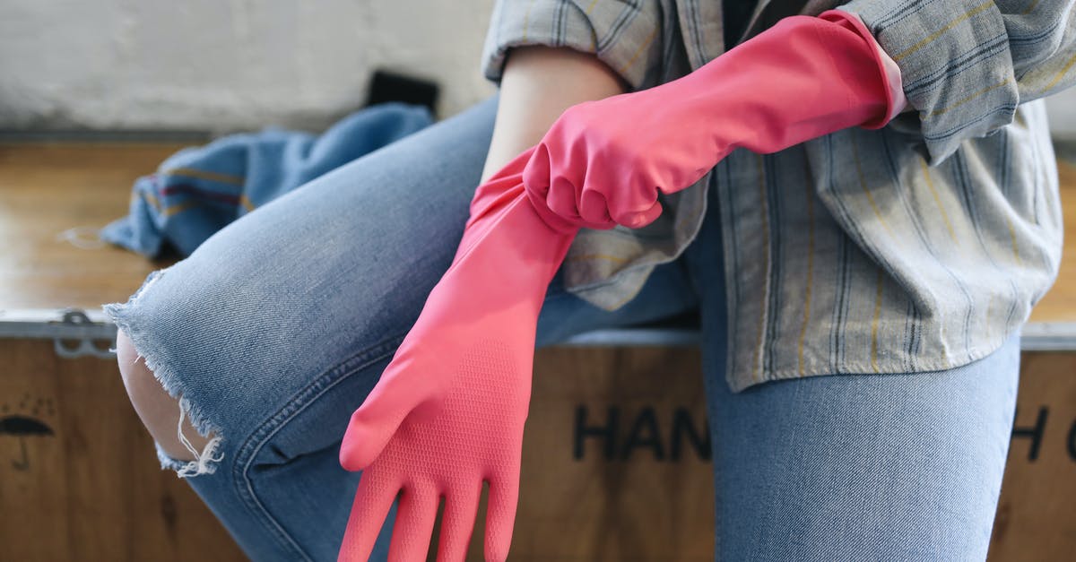 Gloves for newbies pulling sugar? - A Person Sitting on a Wooden Box Putting on Rubber Gloves