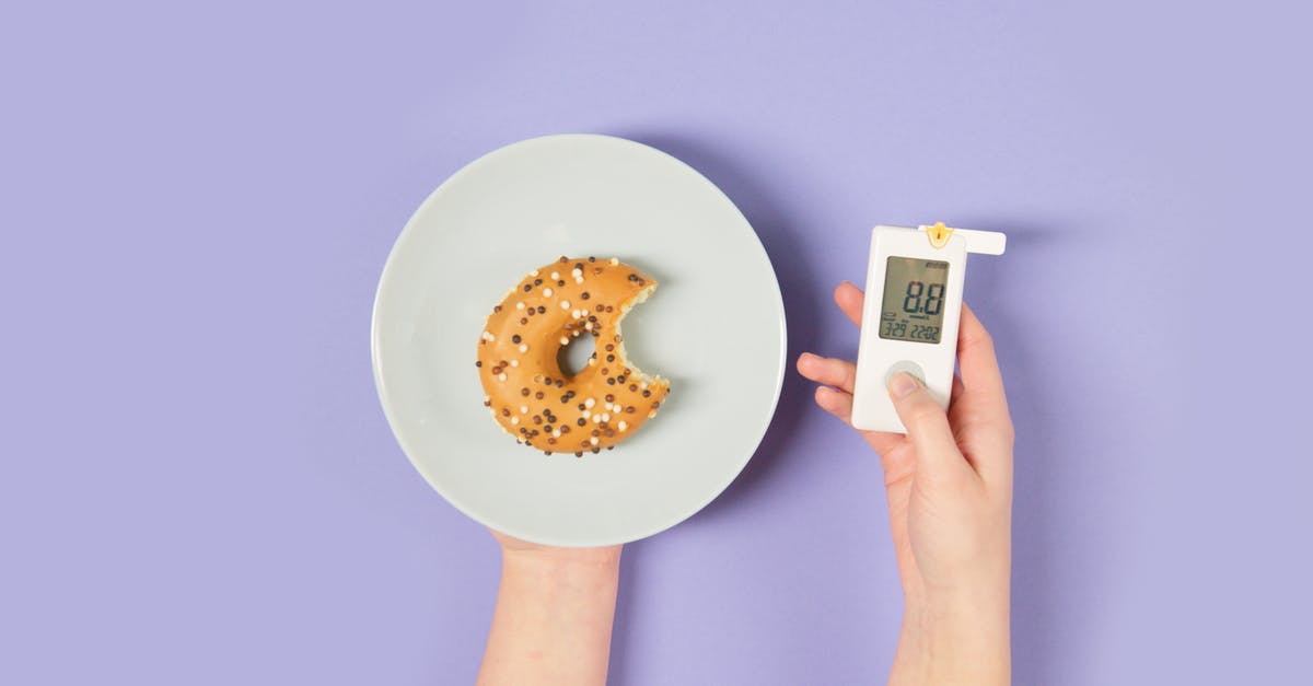 Glucose in sweet bread? - Person Holding a Glucometer and a Plate with a Donut 