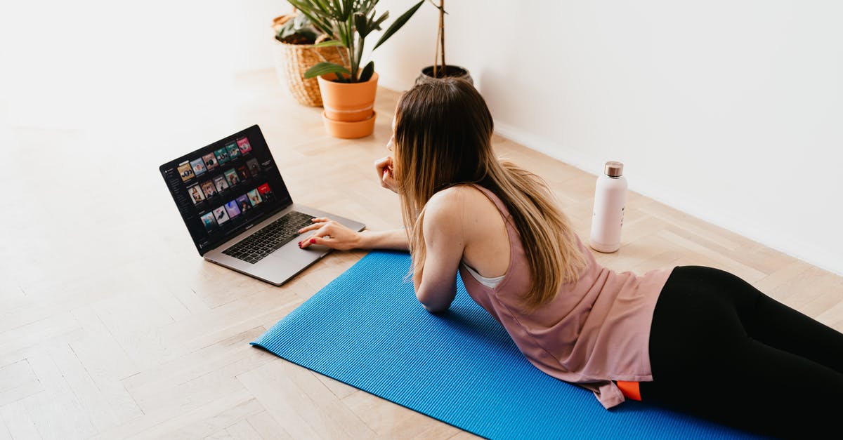 Gluten Free Challah not keeping shape - Young woman lying on floor on mat while using laptop at home