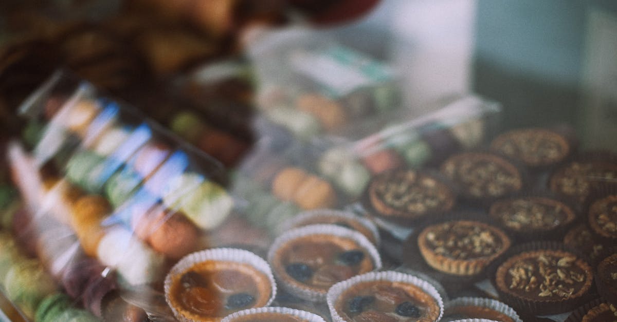 Goal of macerating fruit for marmalade - Through glass view of different tasty tartlets and macaroons for sale in sweet shop