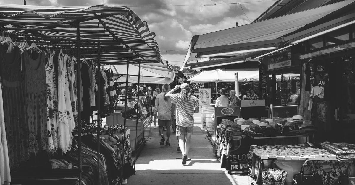 Good Idea to Buy Discount Meat For Freezing? - Black and white of crowd of people strolling in market with different clothes and goods in daytime