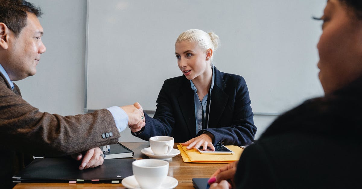 Good programmable coffee urn solution - Group of diverse coworkers in formal suits shaking hands after successful business deal in office