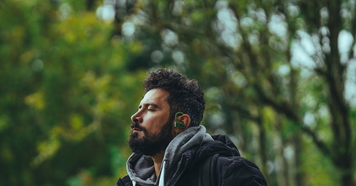 Good uses for leftover Bechamel? [closed] - Contemplative bearded ethnic male in warm jacket listening to music in earbuds while sitting with eyes closed in lush park