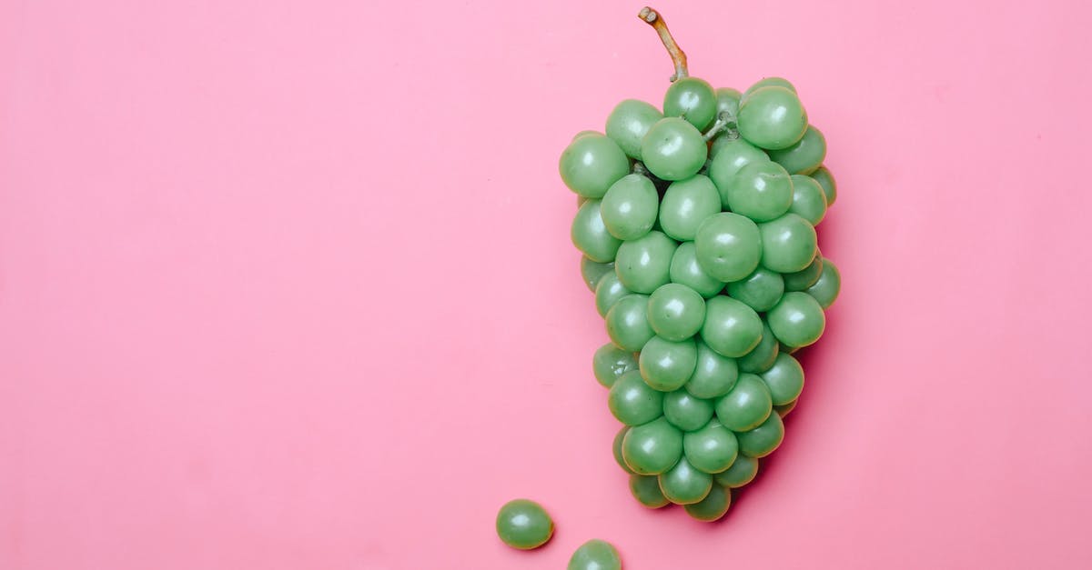 Grape Juice left out overnight, now has fizz - Ripe fresh green grapes on pink surface