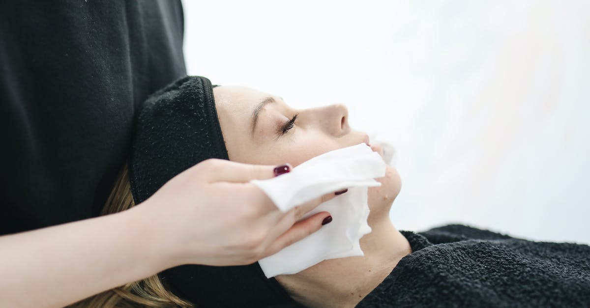 Graphene oxide drying - Photo of Person Using a Tissue to Dry a Woman's Face