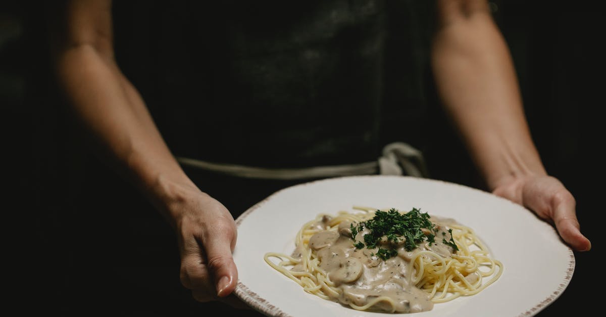 Grey mushroom cream sauce - why so dark? - Person with plate of pasta with mushrooms