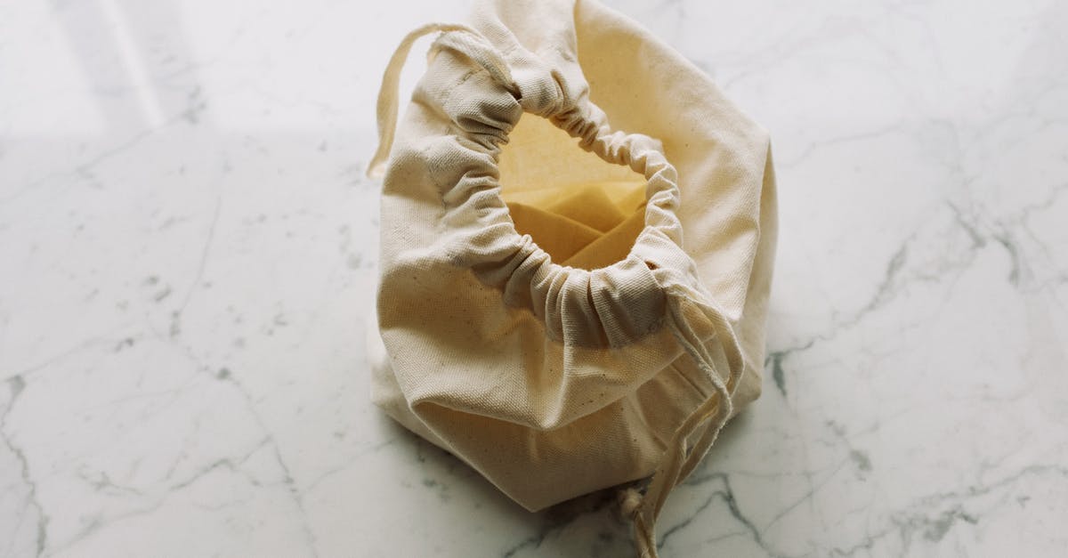 Gritty White Globules in Precooked Grocery Store Sausage? - Top view of empty white fabric sack with drawstrings placed on marble surface in light room Gritty White Globules in Precooked Grocery Store Sausage? - Top view of empty white fabric sack with drawstrings placed on marble surface in light room