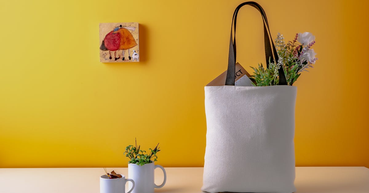 Groceries left out on the counter - Two White Ceramic Mugs and a white bag on Wooden Table