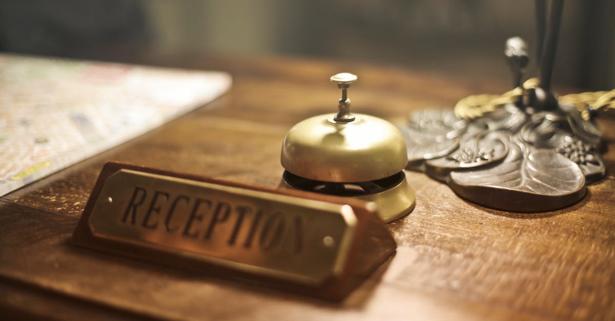 Groceries left out on the counter - Old fashioned golden service bell and reception sign placed on wooden counter of hotel with retro interior