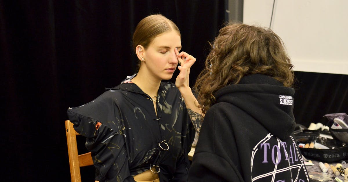 Gumbo base tastes burnt, but the final product does not - Female stylist applying foundation on face of model during preparation for photo session