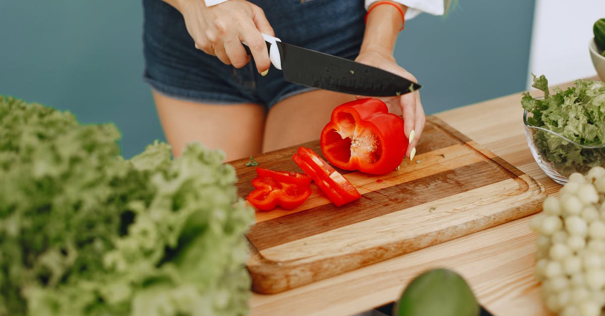 Gyuto knife - What it can & can't cut? What cutting techniques? - Person Holding Knife Slicing Red Tomato