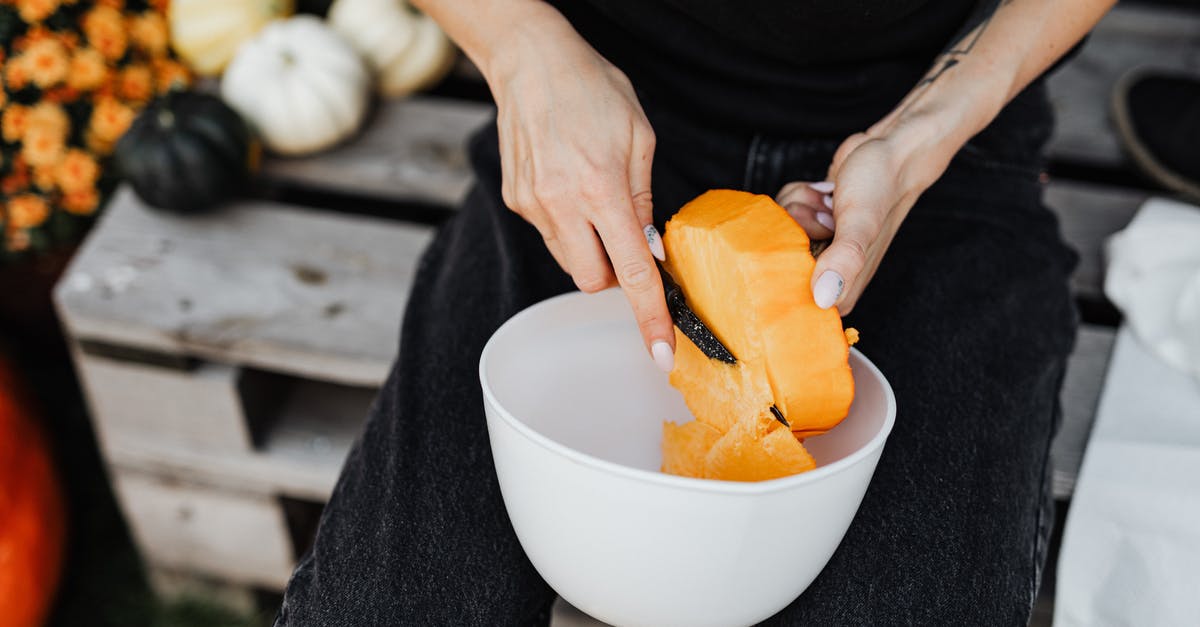 Gyuto knife - What it can & can't cut? What cutting techniques? - Person Holding Sliced Orange Fruit in White Ceramic Bowl