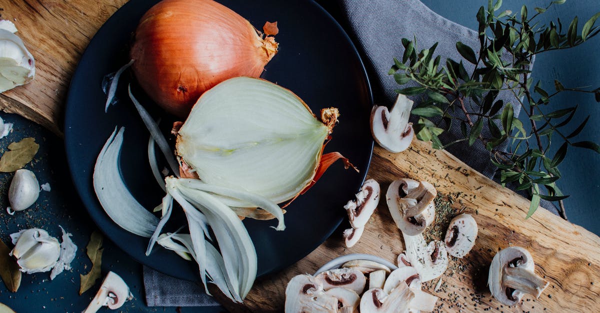 Halving Spice Mixtures - Chopped mushrooms and halved onion on table with herbs and spices