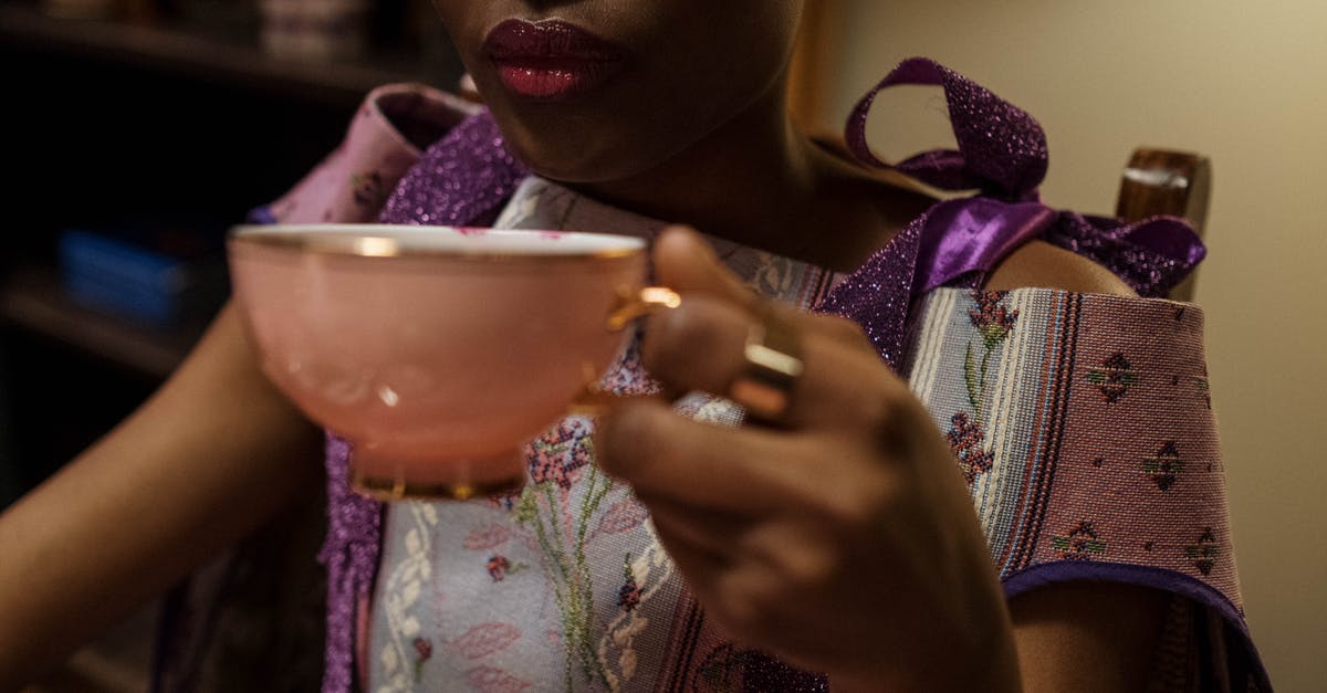 hand cranked ceramic conical burr coffee grinder? [closed] - Woman Holding Teacup