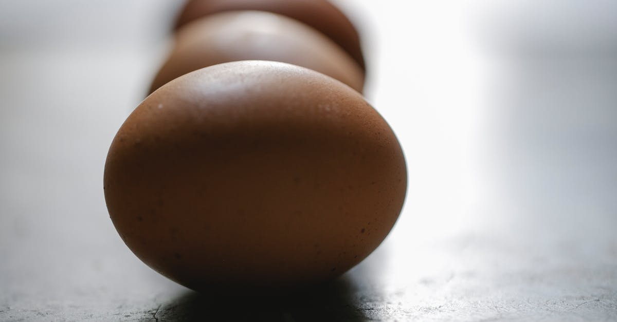 Handling raw poultry turns my cuticles black! [closed] - Row of brown chicken eggs placed on table in kitchen