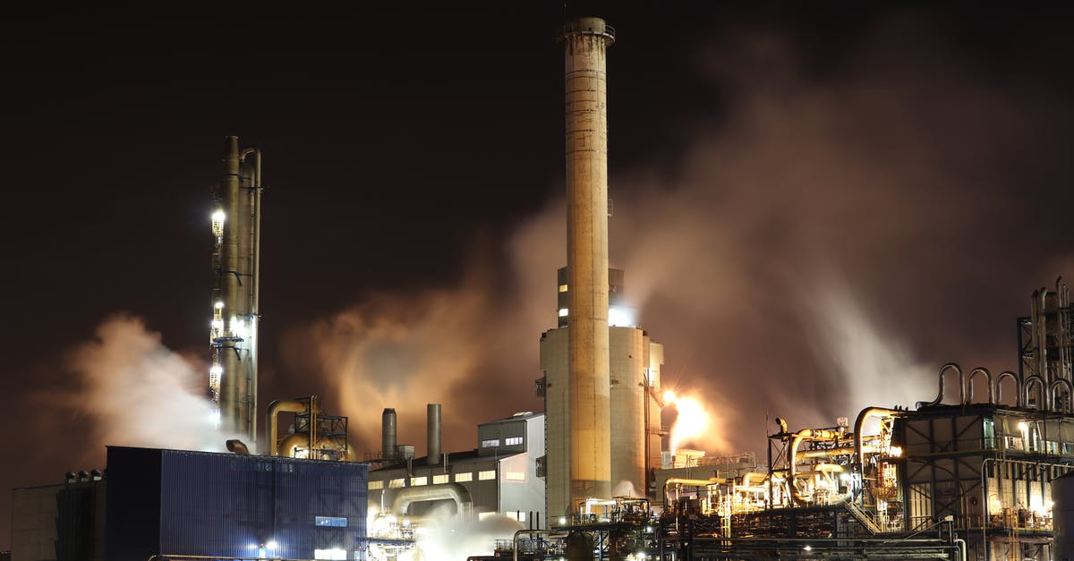 Has the oil started to smoke here? - Brown and White Factory Building during Night Time