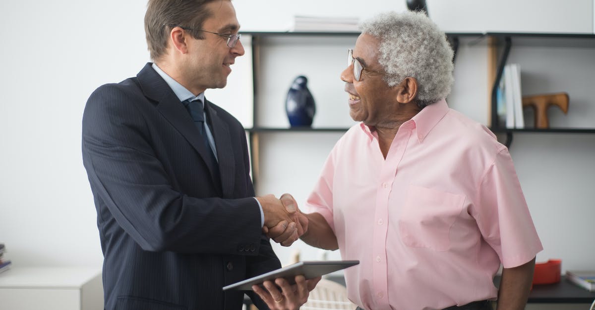 heat-induced leavening agent - An Insurance Agent and an Elderly Man Shaking Hands