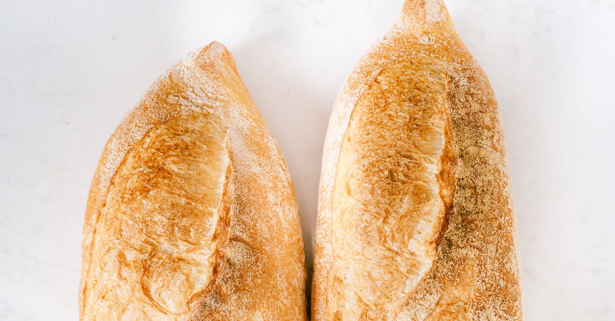 Heating part baked baguettes in lid-covered pyrex - Baguettes on White Surface