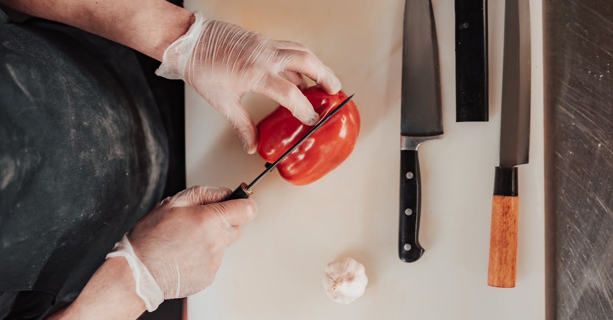 Help with thinly slicing garlic - Person Cutting a Red Pepper 