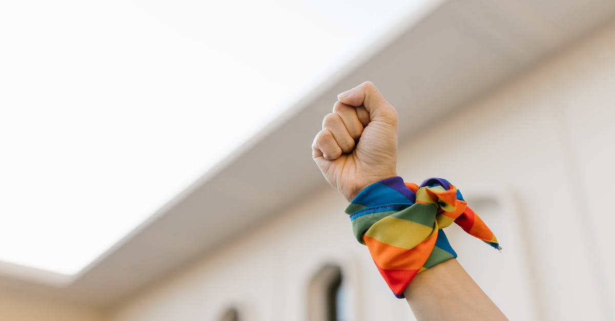 hints for low-carb wraps - Unrecognizable Raised Fist and Wrist Wrapped in Rainbow Cloth 