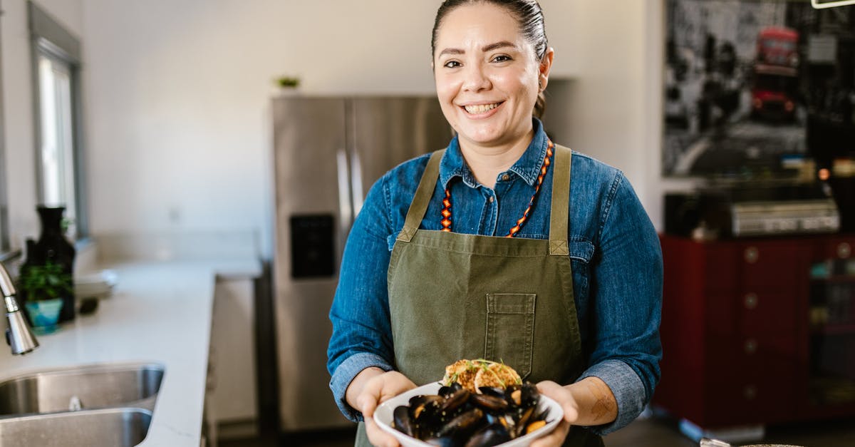 Holding mashed potatoes in fridge before serving - Woman Holding Bowl with Seafood