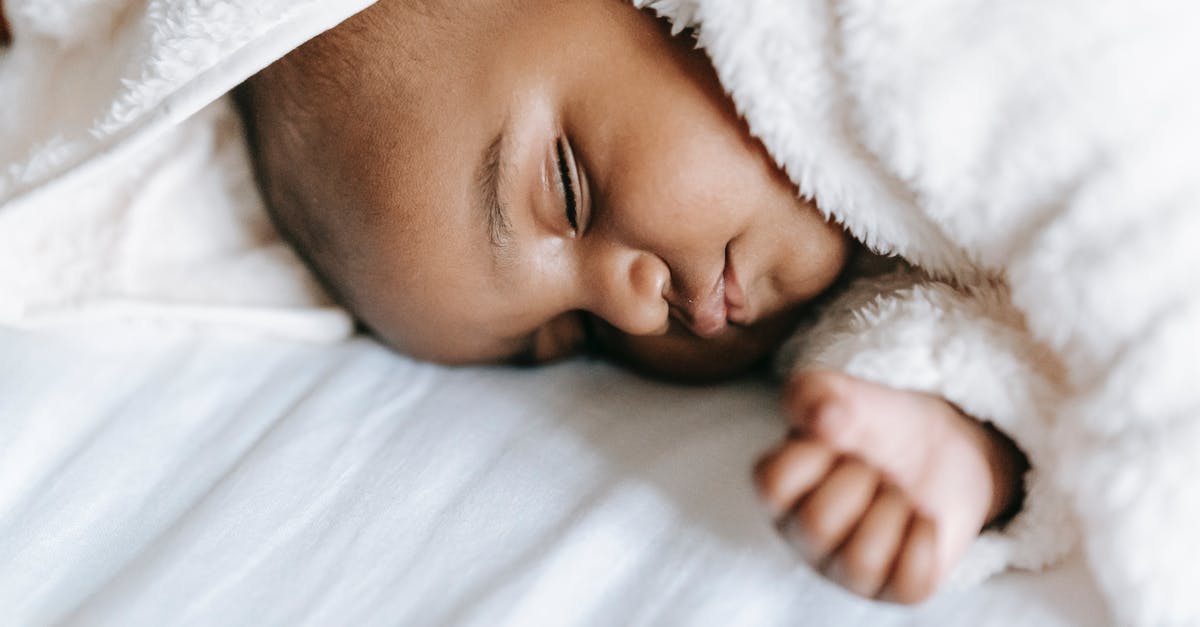 Holes inside a sweet potato - Sleeping newborn black baby lying on bed